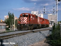 CP train 521 is viewed passing the site of the future downtown Hamilton, Ontario GO Transit Centre at the former Toronto Hamilton & Buffalo Railway (TH&B) station. At the time, construction was ongoing for the modern facility to open the following year on April 30, 1996. Also, the train is passing a new signal bridge that was already installed, however not functioning yet. 521 operated daily from Binghamton New York to Toronto and was powered by SD40 5409, GP9u 8209, RS18u 1803 and RS18u 1848. 