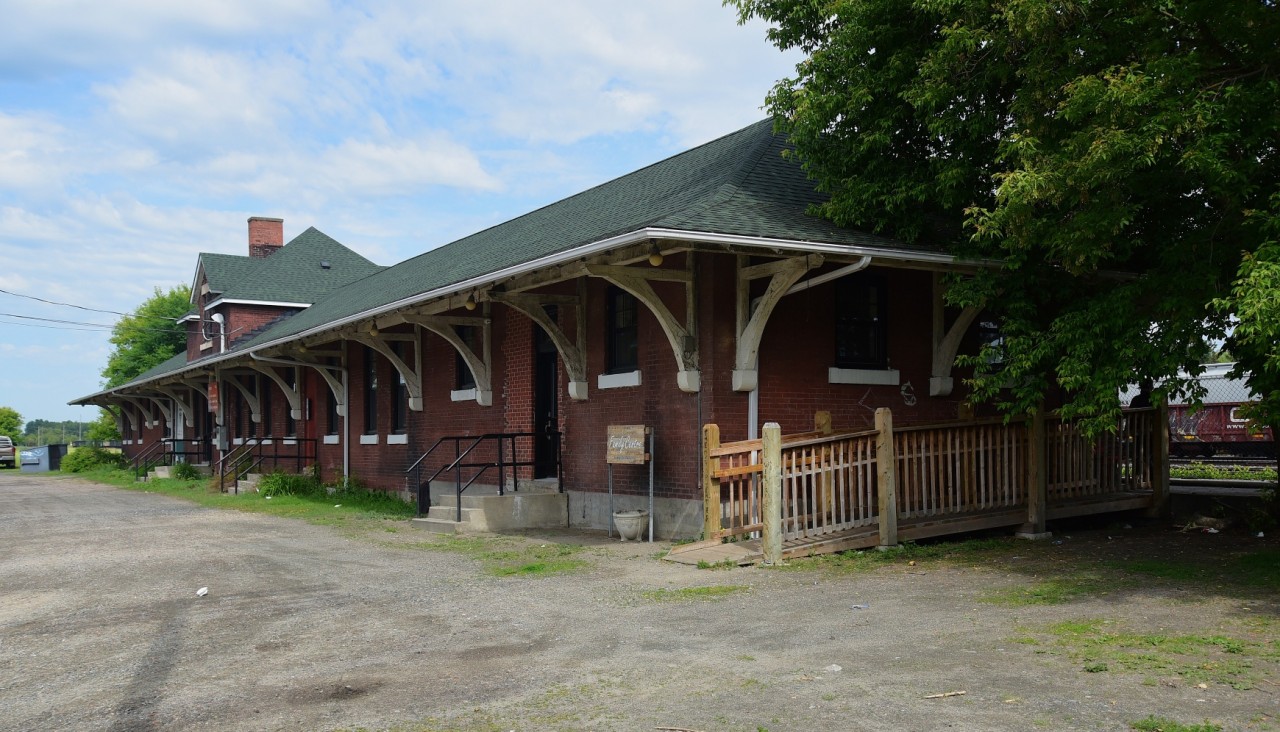 Built 1913 by the CNoR, and in 1928 CNR added an east end extension, the station handled the usual freight and passengers as well as customs and immigration functions.


Acquiring Heritage Building status circa 1984, the building serves as a family social services centre. 



Street side east view, at the former CNoR / CN Fort Francis depot, mile 88.9 Fort Francis Subdivision, June 20, 2025 digital by S.Danko


Unfortunately the rail side view is restricted by a sturdy high fence account the busy rail yard. 


Noteworthy:


 East of the station, Duluth Junction (mile 88.1) is the connection to the rail bridge (Pithers Point built 1908) to Rainier Minn. (east of International Falls, Minn.) and appears to be busy with UP (run through?, witnessed a UP powered unit train westbound approaching Duluth Jct. - no pix!) and CN traffic on the former Wisconsin Central / DW&P (merged into WC 2011 (original 1901 Duluth, Virginia and Rainy River Railway)). 


The former CNoR Winnipeg main line consisting of the Sprague (Symington to Rainy River, including 43.4 miles through Minnesota); Fort Francis; Kashabowie Subdivisions is fully CTC and is CN's only remaining connection to Thunder Bay.


Just east of the connecting wye (Duluth Jct) to Rainier Minn., the CNoR built lift bridge (aka Five Mile Bridge / Rainy River Lift Bridge built circa 1909) over the Rainy River, collapsed August 14, 2024 while the lift portion was being raised. The collapse severed CN access to Thunder Bay until mid September 2024 when temporary repairs were completed. A new bridge is planned and awaiting Transport Canada approval.


At bottom left note the shadow of a telegraph / hydro pole. 


sdfourty