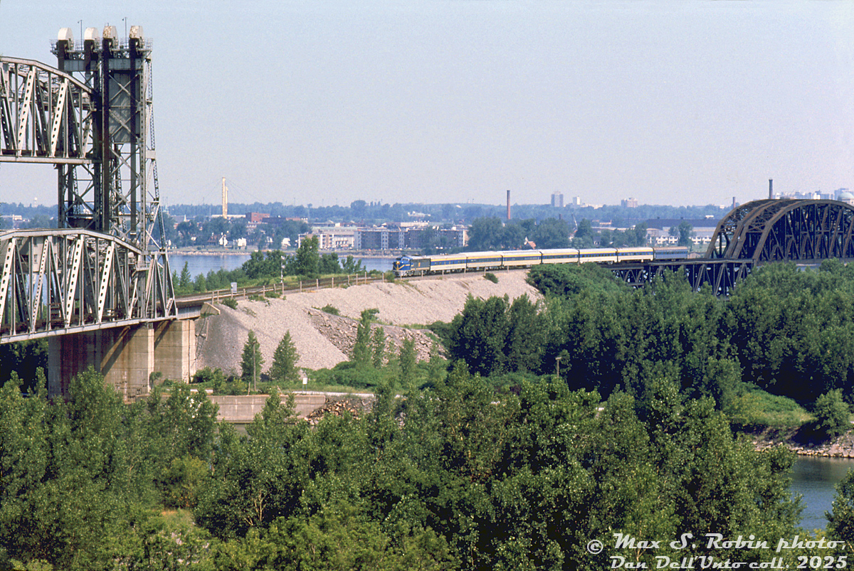 Delaware & Hudson PA1 19 leads seven passenger cars on Amtrak's "Adirondack" passenger train after its departure from Windsor Station in Montreal. It's seen crossing the St. Lawrence River on CP's Adirondack Sub coming off the double track bridge over the river itself, and about to cross the double lift bridge over the shipping canal into Kahnawake, Quebec, enroute to Albany NY in the US.This photo was taken a year after the Adirondack began operating, initially using D&H equipment. Amtrak equipment would later replace the D&H's aging PA's and passenger cars in March 1977. D&H's four PA's (16-19) would then be briefly leased out for Boston commuter service, and later sold to FNM in Mexico.  Max S. Robin photo, Dan Dell'Unto collection slide.