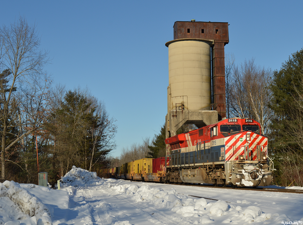 CN X100 - CN 3115 South passes the coal chute at Washago South sporting its sharp looking BC Rail "Hockey Stick" colors on a beautiful December afternoon.