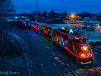 Affectionately referred to locally as the "HO HO" Train pulls out of Kenora. The show is complete, a fresh crew is aboard and it's time to continue west over the Keewatin Sub with a stops at Ingolf, ON and Whitemouth, MB for shows before ultimately arriving in Winnipeg for the final show of the day. The crew boarding 119-11 in the background will have a longer trip than usual having to follow the "HO HO" along the Keewatin.