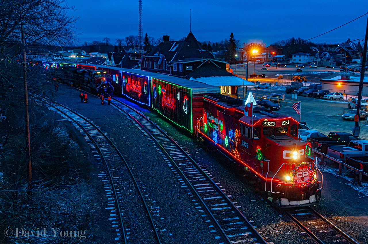 Affectionately referred to locally as the "HO HO" Train pulls out of Kenora. The show is complete, a fresh crew is aboard and it's time to continue west over the Keewatin Sub with a stops at Ingolf, ON and Whitemouth, MB for shows before ultimately arriving in Winnipeg for the final show of the day.  The crew boarding 119-11 in the background will have a longer trip than usual having to follow the "HO HO" along the Keewatin.