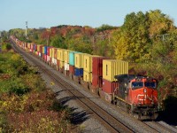 CN 106 passes some fall colours in Beaconsfield with IC 2713 up front (and CN 8882 on the tail end).
