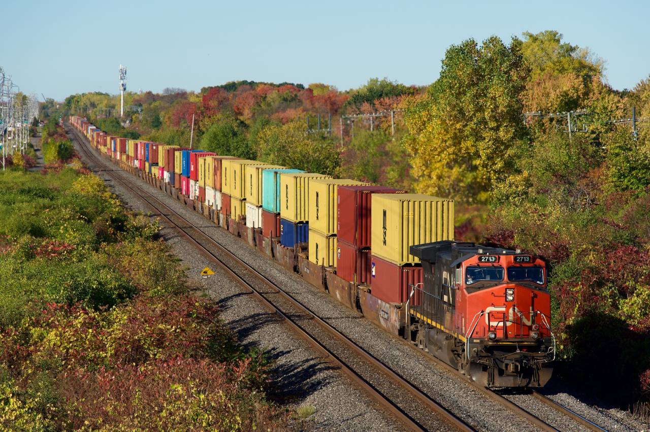 CN 106 passes some fall colours in Beaconsfield with IC 2713 up front (and CN 8882 on the tail end).