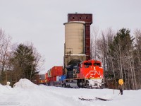 Approaching a meet with 107 at Smail, Q180 cruises through Washago past the 1936 coaling tower.
