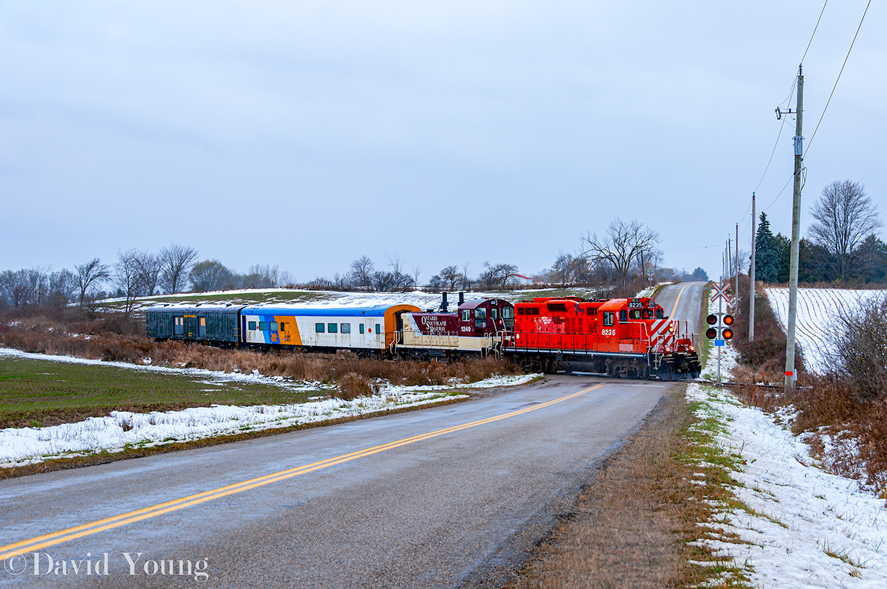 South Pulls North. The first snow is over and now it's a downpour- just an absolutely miserable day. Ontario Southland's St Thomas job is half way home, crossing Crampton Rd outside Mossley with a pair of unusual bedfellows in the form of a former passenger coach and baggage car from the defunct York-Durham Heritage Railway. Disappointing what happened in Uxbridge, but these two pieces have been spared from the scrappers torch and will be painted at OSR's shop in Salford for the VIA Rail Historical Society. Once completed they will head to Mimico to join the organizations other equipment including their FP9u 6539 (the former OSR unit which received the same treatment last year). Sort of interesting capturing a former Ontario Northland coach on the Ontario Southland. Even more interesting having this equipment together as their own train as there was no other traffic ex St Thomas to bring back towards CPKC.