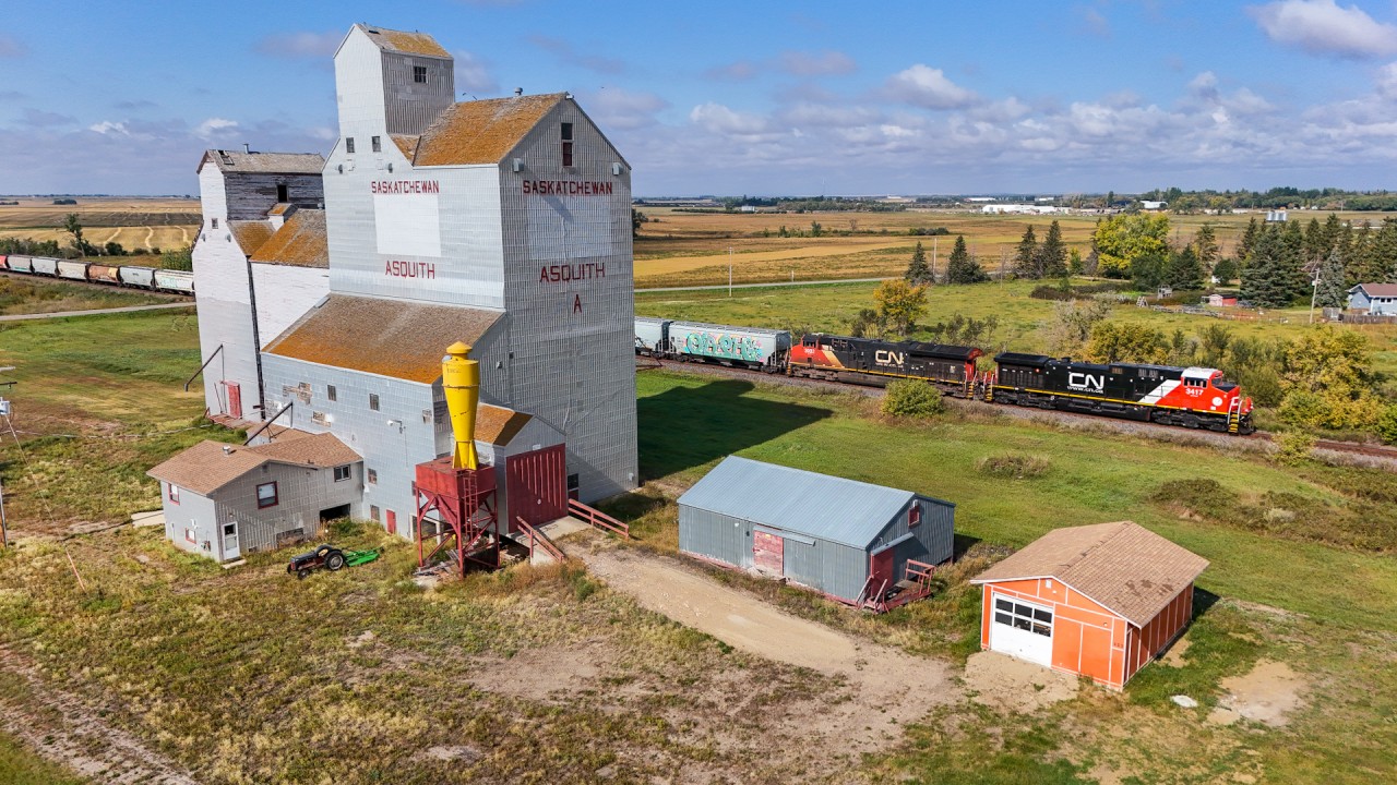 Relatively “new” rebuild CN 3417 cruises past the elevator at Asquith with Edmonton to Melville train G 84251 15.