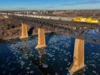 The North Saskatchewan River is starting to freeze over, as EMDX 7206 shoves a 100 car train into Edmonton from the Crush plant at Dufualt, Saskatchewan.  