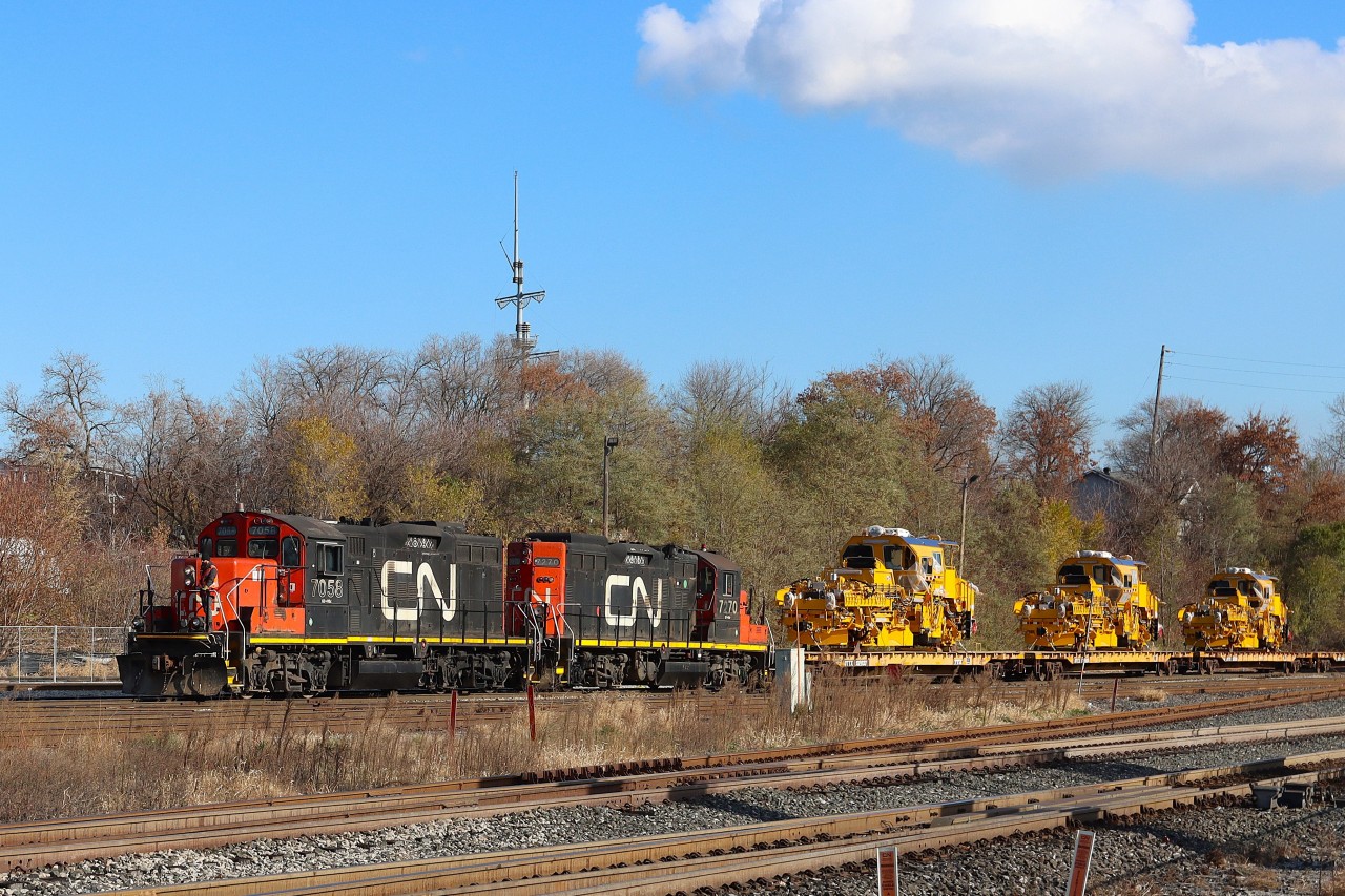 With a couple of veteran GP9RM's leading the 0600 Hamilton Yard Job is returning from their days work with a last minute lift request, six dimensional loads (D2U) from the Harbour Area. The six loaded flats consisted of three Plasser American USP 2005 Ballast Profiling Machines first up followed by three Plasser American Unimat 4X4/4S High Performance Tampers. METROLINX stenciling was prominent on the machines.