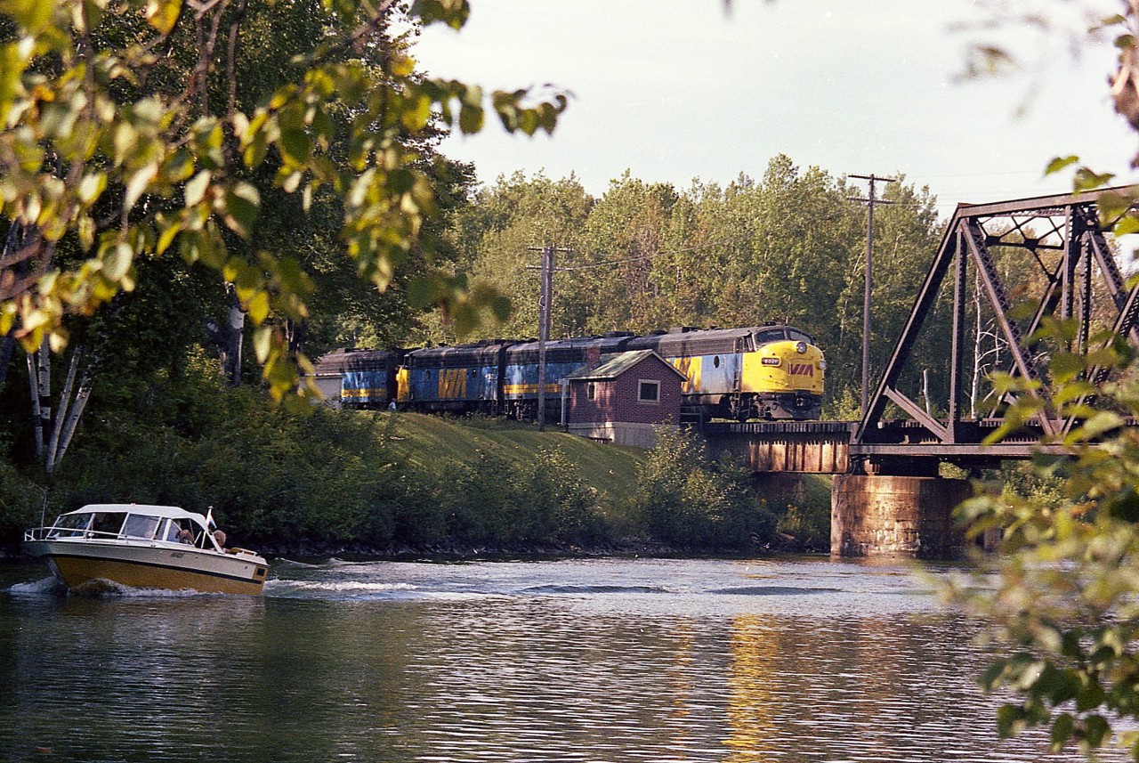 Nice warm early fall afternoon and the "Super C" is southbound over the Trent-Severn waterway by way of the historical CN swing bridge (or Drawbridge, in RR terms). The power is VIA 6521, 6623, 6533. This location is but a mile out of Washago. Back in the day, Washago was a great place to hang out as there were a good number of CN freights as well as the ONR Northlander. I am assuming the structure by the bridge is the bridge tender's quarters.