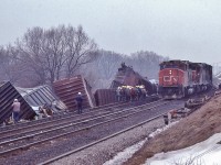<br>
<br>
Creeping at 5 m.p.h., CN 9614 East – first east bound freight. 
<br>
<br>
   At CN Beachville, February 18, 1984 Kodachrome by S.Danko
<br>
<br>
 February 14, 1984: A  25 car CN train derailed four miles west of Woodstock ( Beachville) causing $1 million (1984 $) damage. Half mile track torn up, propane tankers included in consist. Heavy rains blamed for weakening the track bed. Reportedly every spring new remnants of the derailment can be seen along the Beachville Thames River Trail – pushed up by the winter frost.
<br>
<br>
 more Beachville
<br>
<br>
     <a href="http://www.railpictures.ca/?attachment_id=  46091">  track crew </a>
 <br>
<br>
     <a href="http://www.railpictures.ca/?attachment_id=  46028">  foreman </a>
 <br>
<br>
    <a href="http://www.railpictures.ca/?attachment_id=  50490">  Kinky </a>
 <br>
<br>
sdfourty


