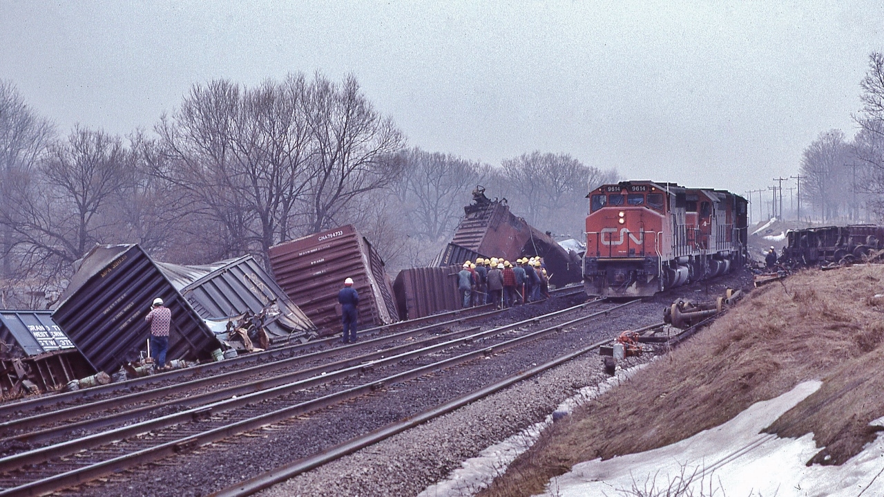 Creeping at 5 m.p.h., CN 9614 East – first east bound freight. 


   At CN Beachville, February 18, 1984 Kodachrome by S.Danko


 February 14, 1984: A  25 car CN train derailed four miles west of Woodstock ( Beachville) causing $1 million (1984 $) damage. Half mile track torn up, propane tankers included in consist. Heavy rains blamed for weakening the track bed. Reportedly every spring new remnants of the derailment can be seen along the Beachville Thames River Trail – pushed up by the winter frost.


 more Beachville


       track crew 
 

       foreman 
 

      Kinky 
 

sdfourty