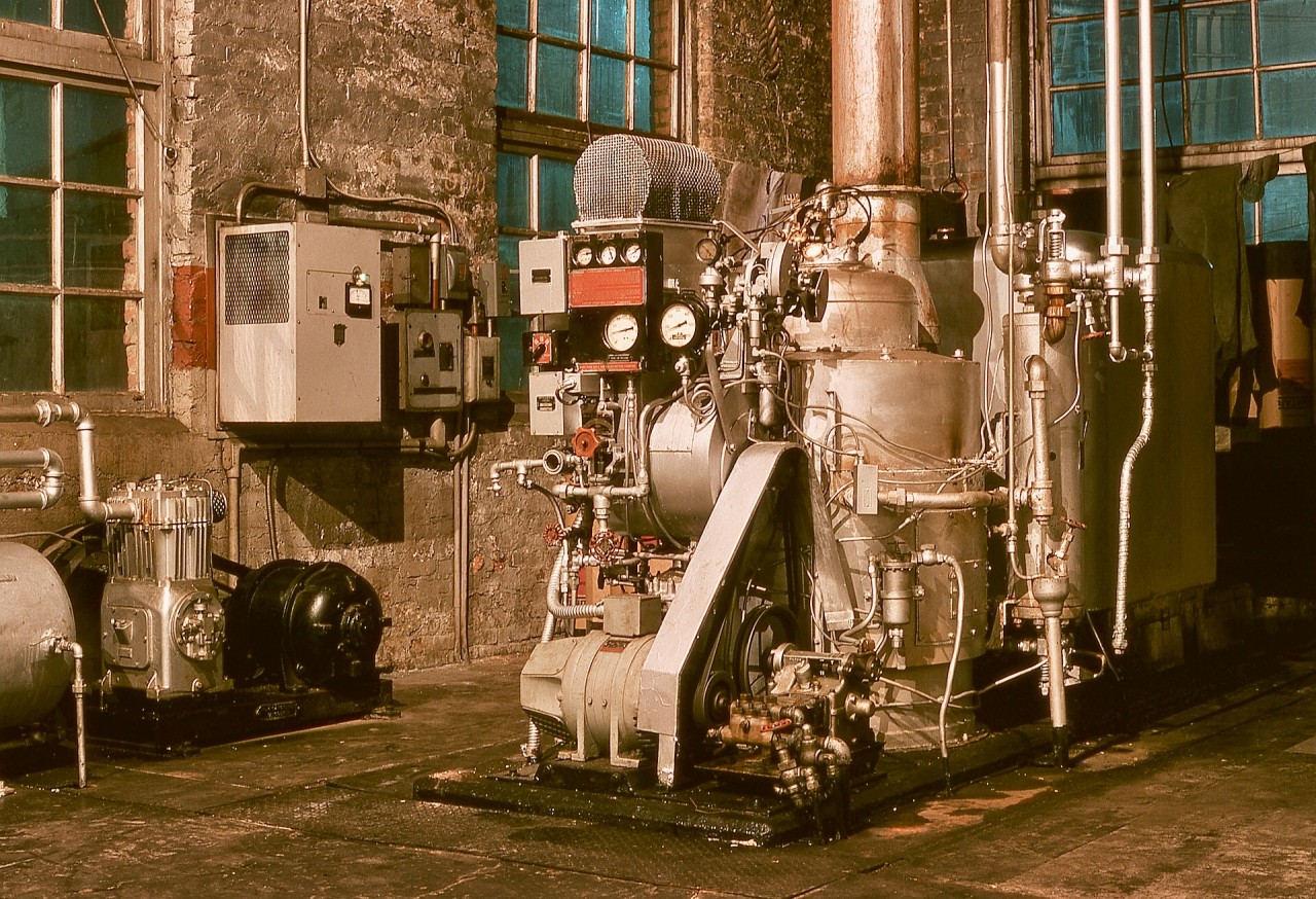 The boiler room at the E&N roundhouse in Victoria used to have two conventional boilers to provide steam to a next-door engine room (for powering shop machinery by lineshafts), as indicated by two tall smokestacks in early photos.  When CP acquired thirteen Baldwin roadswitcher units in 1948, the first five, 8000 to 8004, had one Vapor Clarkson DRK-4516 steam generator in each short hood for handling passenger trains, and when Budd RDCs took over passenger operations starting in 1955, those steam generators, possibly the first on CP, were surplus, so one was used to replace the two boilers, by then used only for shop heat.

As a lone worker on graveyard shift, the pictured steam generator was my friend when it behaved, and I became well attuned to its sound repertoire, and comfortable with firing it up for dayshift on cool mornings.  In later years, an inattentive manager allowed it to run dry, and meltdown resulted, with an OK-4625 generator from an F-unit eventually brought in as a replacement.