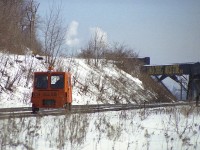 Something different you do not see any more......unless perhaps you are one of those aficionados that enjoys outings on your own personal machine.
Speeders were once common as track patrol vehicles, and I used to see this one regularly along the Dundas. I don't know where he set out from but assume he went as far as Bayview and then returned. Brantford? Anyway, here is CN 15268 rolling west past the old Canada Crushed Stone conveyor structure around mile 4.4 on the Dundas. The track remains, of course, but the rest of the scene is history.