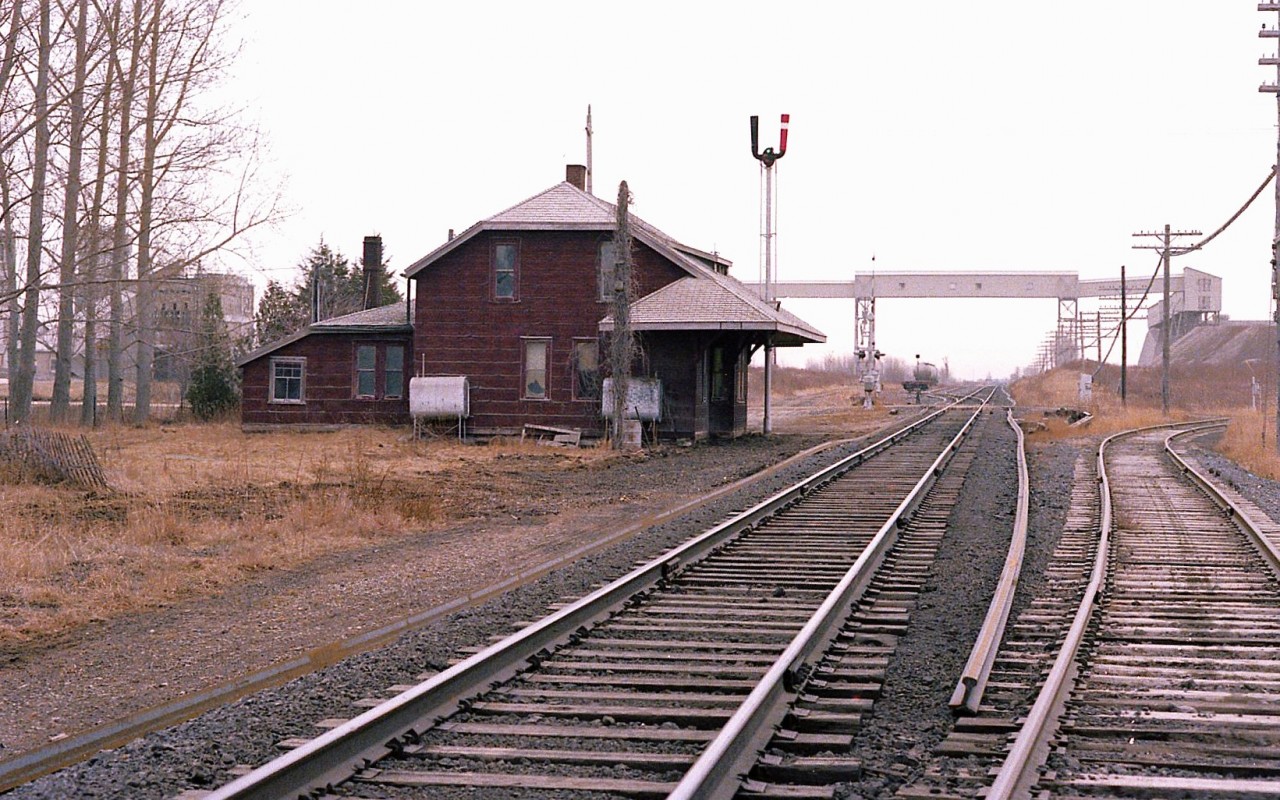 It is hard to keep track of what I have posted and what I have not.  I do not remember this one going to RP.
Anyway, a nondescript sort of day, and I am out at the old Zorra station, hoping for some action.  This view is looking east along the Galt sub; with Lafarge structures visible as well as the line to Ingersoll on the right.
Most of what you see other than the main line is long gone, although Lafarge (concrete) still operates here. The station was a classic. Heck, it could boast two oil tanks !!! That is a lot of heating. No wonder it was demolished.
This is my last contribution for 2025. Happy New Year, everyone.