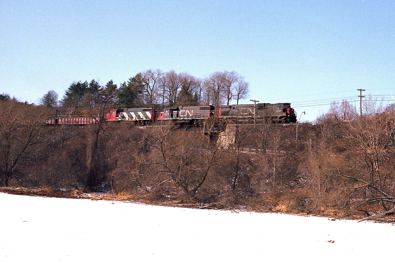 So it is a very cold February day and I am out on the harbour ice for a change (why not?) as I know #432 is coming out of Hamilton.  Just did this to try a different angle. CN 2007, 5518, 5563 power this now eastbound train seen rumbling over the old Valley Inn Rd bridge on its' way to Mac Yard. Recently this road has been closed to vehicular traffic and I would no longer trust the harbour ice.