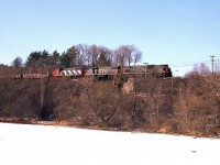 So it is a very cold February day and I am out on the harbour ice for a change (why not?) as I know #432 is coming out of Hamilton.  Just did this to try a different angle. CN 2007, 5518, 5563 power this now eastbound train seen rumbling over the old Valley Inn Rd bridge on its' way to Mac Yard. Recently this road has been closed to vehicular traffic and I would no longer trust the harbour ice.