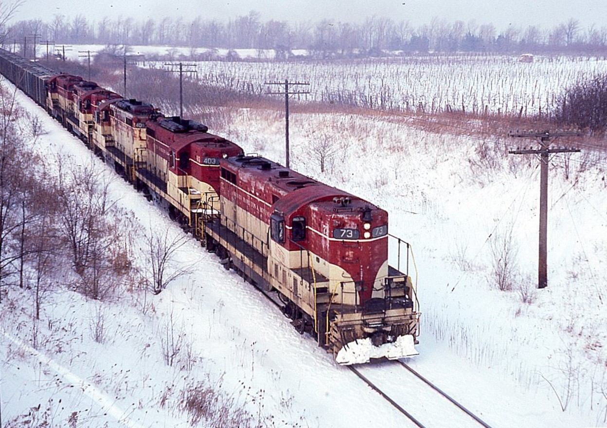 Close-up shot of the power as TH&B has just crested the hill at Vinemount and is heading down to Port Maitland. Units are: TH&B 73, 403, 401, 75 and 76.  Photo from the Ridge Road overpass.