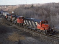  An Eastbound coasts down the grade through Hamilton Jct and on towards the Oakville Sub. During the eventual triple tracking of the Oakville Sub in the 2000's, some bean-counter decided to remove the signal plant at Hamilton Jct and combine it with Bayview. This meant the RTC when giving a headroom light on track 1 at Bayview effectively was unable to line up an Eastbound train on the North track at Copetown, or get a shorter train such  as VIA ahead at Bayview (old Ham Jct). 