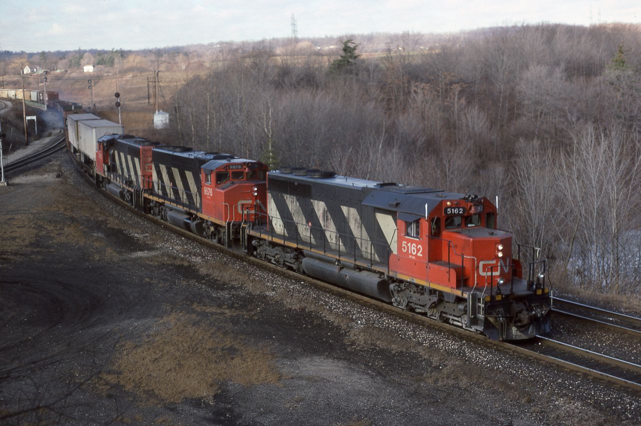 An Eastbound coasts down the grade through Hamilton Jct and on towards the Oakville Sub. During the eventual triple tracking of the Oakville Sub in the 2000's, some bean-counter decided to remove the signal plant at Hamilton Jct and combine it with Bayview. This meant the RTC when giving a headroom light on track 1 at Bayview effectively was unable to line up an Eastbound train on the North track at Copetown, or get a shorter train such  as VIA ahead at Bayview (old Ham Jct).