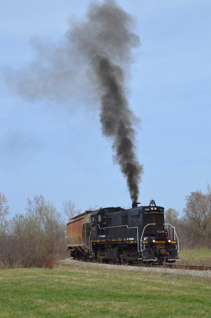 Smoking up like a nice old MLW unit should, Trillium 108 works a cut of cars at that diminutive yard down by the former Robin Hood facility. The old warrior put on quite a show.