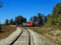 Quiet branchline railroading near Ontario's Saugeen Shores, CN 4377 backs around the wye at Port Elgin, taking the north leg over to the Southampton Spur.  They'll soon lift their train and depart for Stratford.

<br><br>It would appear that the spur in the foreground, built in 1970 for the Bruce Nuclear Power Development plant at Douglas Point, was reassigned as the Southampton Sub main at some point.  Canadian Transportation Commission Order 35400, issued July 25, 1983, authorized the abandonment* of "b) the Southampton Spur, off mileage 48.19 of the Southampton Subdivision, from a point near Port Elgin (mileage 0.90) to Southampton (mileage 5.00), a distance of 4.10 miles."  This of course had been the mainline to Southampton.

<br><br>*CTC Order 35400 authorized the abandonment of the following lines:

<br>a) the Durham Spur, off mileage 1.3 of the Owen Sound Subdivision, from Whites Junction (mileage 0.00) to Durham (mileage 25.72), a distance of 25.72 miles;

<br>b) the Southampton Spur, off mileage 48.19 of the Southampton Subdivision, from a point near Port Elgin (mileage 0.90) to Southampton (mileage 5.00), a distance of 4.10 miles;

<br>c) the Kincardine Subdivision from a point near Listowel (mileage 1.41) to Kincardine (mileage 57.82),La distance of 56.41 miles; and

<br>d) the Fergus Subdivision from a point near Fergus (mileage 47.00) to a point near Palmerston (mileage 72.00), a distance of 25.00 miles.