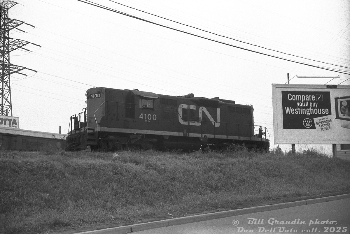 CN 4100, one of the lightweight freight/passenger service GP9's assigned to Spadina Roundhouse, works a local freight switching on the Newmarket Sub just south of St. Clair Avenue station  It's seen switching the lead on the east side along Caledonia Road leading to Darrigo Brothers, Caledonia Food Distributors and Meschino Banana Company.

The building and loading dock for Pietro Culotta is visible in the background, along with a PGE reefer spotted at one of their sidings. Due to its proximity to Little Italy, this area between Davenport and St. Clair had numerous Italian and Portuguese wine and produce suppliers that received grapes transported in reefers from California.

Also of note, this spot north of Davenport along Caledonia was once the site of the old N&NW Davenport Station, replaced by the new CN St. Clair Avenue station to the north in the early 1930's when this section underwent grade separations for Davenport and St. Clair.

Bill Grandin photo, Dan Dell'Unto collection slide.