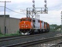 Nearly new (3 months old at the time) CN SD50F units 5453 and 5450 lead C630M 2036 on a westbound freight, coming off the Halton Sub at Burlington West (note the added "West" sign).
<br><br>
The new full-bodied Draper-Taper cowl units, CN's second SD50F order from GMD, were still being built with EMD's 645F engine despite EMD already introducing the 710G in the SD60 model three years earlier (and CN ordering 4 prototype SD50AF units equipped with the 710G two years earlier. Perhaps CN hadn't fully assessed them yet). It would be another two years before CN ordered their first 710G-engined SD60F units (5504+).
<br><br>
<i>Bill McArthur photo, Dan Dell'Unto collection slide.</i>