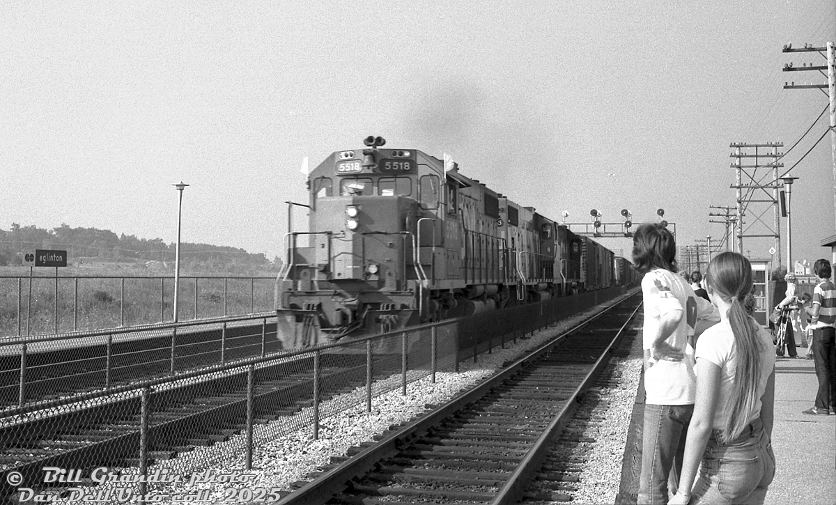 With white extra flags waving in the wind, an eastbound extra freight lead by CN GP38-2 5518, a GP38-2W, and another GP38-2 zips through Eglinton GO station, catching the eye of waiting passengers on the platform awaiting the arrival of the next GO train inbound to downtown Toronto.

Bill Grandin photo, Dan Dell'Unto collection negative.