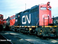 CN SW1200RSm 7100 and GP9RM 4130 are pictured waiting to depart the MacMillan Yard diesel shop tracks on an outbound train in Vaughn, Ontario.