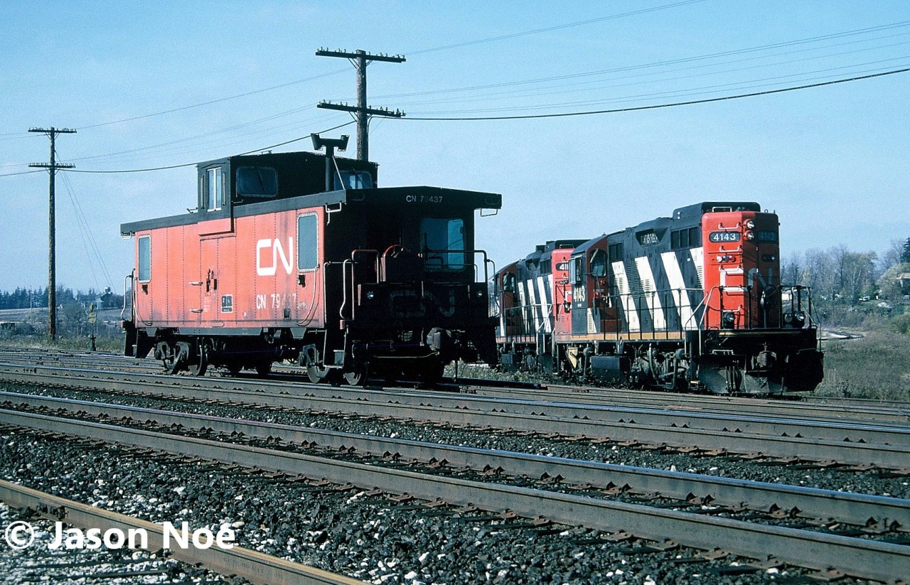 CN train 555 with GP9RM’s 4143 and 4112 are pictured working the Paris pit trackage along the Dundas Subdivision. On this day they had van 79437 and would eventually depart caboose hop to Brantford after their work was completed.