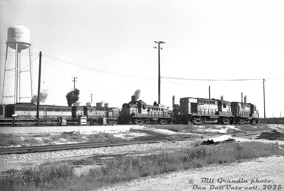 MLW units dominate the tracks around the diesel shop at Canadian Pacific's Agincourt (Toronto) Yard in east end Toronto. Visible from left to right are FB1 4409, RS10 8583, RS3 8430, RS10 8596 and RS18 8740. A lone GMD product is visible in the form of TH&B GP7 71, tucked away between CP units. A few tracks over, three other MLW units out of view appear to be load testing, or marking their territory against the London-built invader.

Bill Grandin photo, Dan Dell'Unto collection slide.