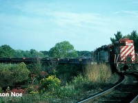 While waiting for a CN westbound by Old Guelph Road near Hamilton West, at Mile 1 of the Dundas Subdivision, we heard a CP ballast train departing Hamilton on the scanner. With the late September evening light slowly starting to fade, we decided to photograph it nearby from where we were as much of the Hamilton Subdivision would already be shadowed in. 
<br>
Here CP GP9u 8200 and SOO Line SD40-2 6608 lead a northbound ballast train around the curve approaching the over/under with the Dundas Subdivision. The power had just crossed the bridge over the QEW as evidenced by the large telephone poles in the background. 
