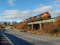 CN 5793, an SD75I, leads a short train 562 over the Des Sauvages creek bridge just east of Amqui. When i began chasing this train with my friend Mathieu, it was looking to be a rather grim day weather wise. The skies were covered with clouds and we even came across some rain on the way, luckily, towards the end of the day, the sun came out to light up the best part of the trip.  