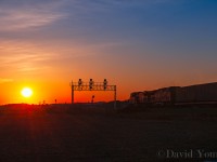 <b>The Evening Wolverton Came Online.</b> The sun sets over the fields west of Cambridge as train 159-27 enters the new siding at Wolverton. The old ABS signals still stand beneath the new signal bridge, turned away and out of service, their purpose now redundant. The original siding will remain as a future storage track for the yard that will built here in the coming years. 159 will be the first of 3 westbounds block-on-block (Ham Turn and 243) to squeeze into the new 10,000 foot siding to meet 5 eastbounds. 