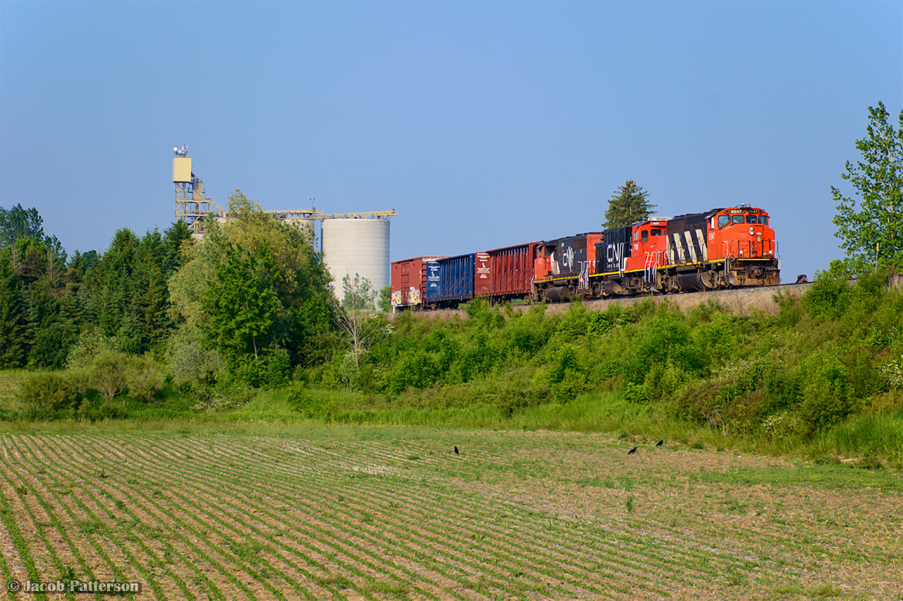 Highballing home to Kitchener, L540 whips past P&H Shantz Terminal with cars from Gillies Lumber in Galt.