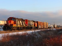 At 70 years old, CN 4125 leads L551 eastbound on the south track passing a work crew and machinery preparing ductwork at Appleby Line overpass for fibre-optic cable installation to the Milton Logistics Hub.