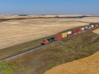 Railfanning in a location where two rail lines operate in close proximity is a blessing and a curse.  Sometimes the trains come at the same time and you can’t be in position for both.  Figuring that CPKC 577-117 and CN X 11651 18 would converge in the Keppel area, I picked a location where I thought they’d meet to try for a drone shot.  Down on ground level, I had to pick one railway or the other… I set up on the CPKC Hardisty Sub, a thousand feet north of the CN Watrous Sub - CN trains here are plentiful, CPKC are not. 

With CN arriving first, I flew the drone eastward alongside X 11651 18 hoping there would be a tailend remote.  As luck would have it, the 3310 was facing westward and CPKC 577-117 came into view through a cut in the farm fields.   My timing was a few moments off, the drone doesn’t move a mile a minute like the train does!  Not quite the shot I wanted, but not bad for a guess of where two trains would meet.   I guess I’ll have to head back out to the Biggar area and try again next year.  
 

X 11651 18: CN 3941, CN 3310 – DP 1x0x1 – 125 cars
CPKC 577-117: CP 8009, KCS 4801 – 128 cars