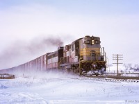 An eastbound CPR freight kicks up the snow approaching the Highway 2 crossing between Cobourg and Spicer.

<br><br><i>Scan and editing by Jacob Patterson.</i>