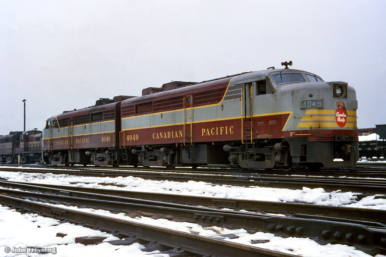 Burbling away on the shop tracks at Lambton yard, CPR 4049, 4048, a pair of MLW FA2s, await the call to duty.  Both built in 1951, 4048 will be traded in to MLW in 1965 for C424 4206, while 4049 will be wrecked in northern Ontario in 1972.

Scan and editing by Jacob Patterson.