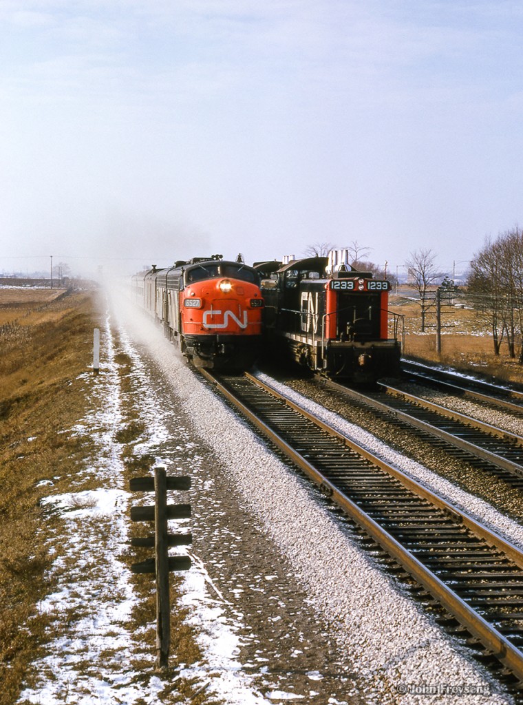 Just west of CN's Pickering station, Toronto - Montreal train 14, the Lakeshore, flies past the Toronto - Oshawa wayfreight.

Scan and editing by Jacob Patterson.