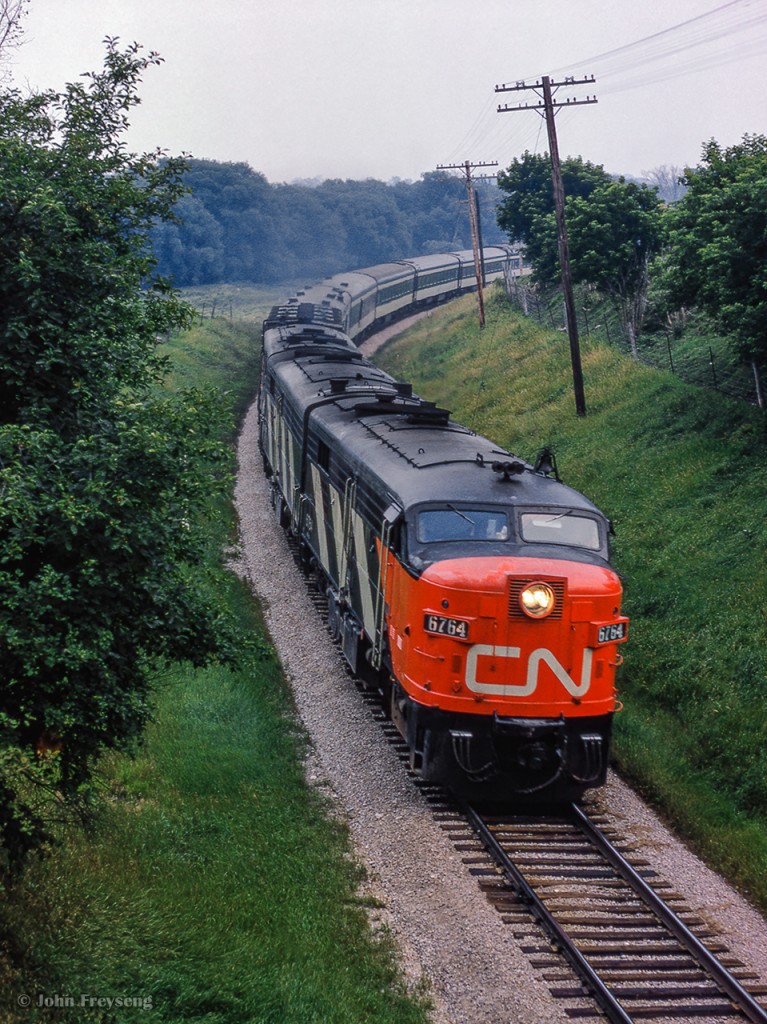 North of Newmarket, CN's westbound Super Continental rounds the curve near mile 36.

Meeting of Super Continental's at Aurora:
3 in the siding
4 approaching on the main
The meet

Scan and editing by Jacob Patterson.