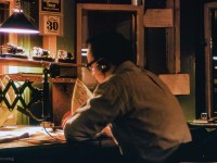 CPR train order operator John F. Mellow is seen at work, copying out orders at Don Station on a chilly winter night.  Employed by the CPR as an operator/dispatcher for 15 years, and later 29 years with GO Transit, John was heavily involved for many years with the Upper Canada Railway Society, Ontario Rail Association, South Simcoe Railway, the Friends of Freeman Station in Burlington, Toronto Railway Museum, and various other rail preservation projects.<br><br>"Every time I see a picture of Don Station, I think of my dear friend John. Can hear him repeating the train order he is writing down, spelling out numbers, hunched over the train order sheet, in the quiet of the night. This is how I like to remember John, and I feel blessed to have shared many wonderful and enjoyable times with him throughout his remarkable life."  1945 - 2025.<br><br><i>Scan and editing by Jacob Patterson.</i>