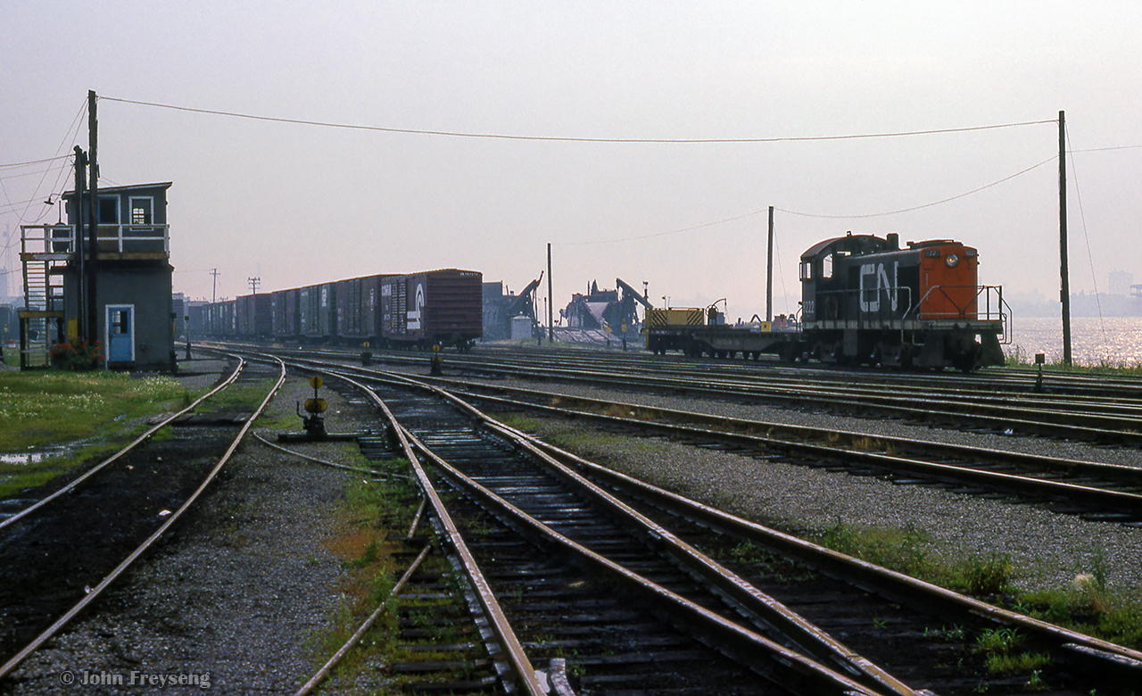 CN 8222 is assigned to Windsor Yard on a humid summer day in July 1978.  With idler flats attached it appears a car float has just been unloaded, or is about to be loaded for a trip across the Detroit River.

Scan and editing by Jacob Patterson.