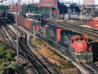 With passenger movements briefly in the clear, a handful of freight movements can get underway.  An eastbound freight behind CN 5074-5072-9424 approaches Bathurst Street, while a westbound swings around behind Cabin D, led by CN 3230-3201-4521-3120.  A van hop waits over on the Weston Sub to shove into TTR territory.

<br><br><i>Scan and editing by Jacob Patterson.</i>