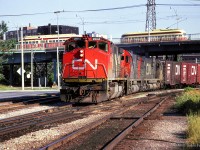 CN Extra 2514 makes its way down the Bala Sub, passing under Queen Street, where TTC streetcars are seen meeting.

<br><br><i>Scan and editing by Jacob Patterson.</i>