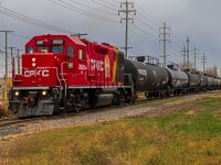 A freshly painted CPKC 3092 leading a line of tanker cars through the St. James neighborhood. On their way back into the CPKC Higgins yard.