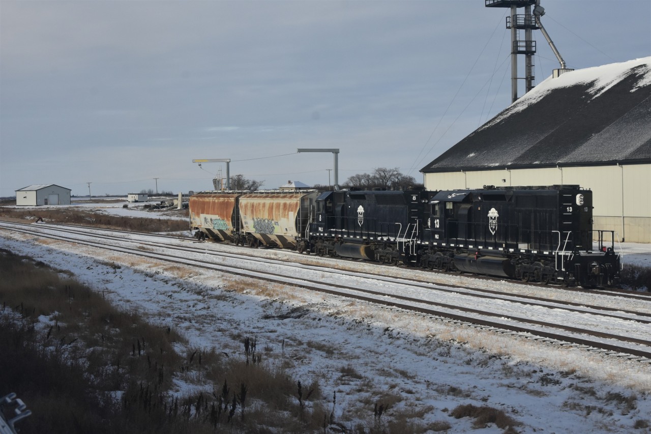 Grain train  
PHLX 8 and PHLX 13 shuffle a couple of grain hoppers within the confines of the Parrish & Heimbecker, Limited grain elevator yard trackage at Oban, SK situated at Mile 8.6 on CN's Wainwright Sub.