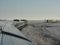 <b> Prairie meet </b> <br>
VIA 002 The Canadian is in the hole for a CN grain train on a frosty cold November 30, 2025 morning.