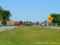 Not many railways cross what you may consider a 'divided highway' and this is one of the few spots in Canada. <br><br>
Pictured is CN 542 crossing Highway 6/7, the "Hanlon Expressway" in Guelph. Construction has begun on the new highway 7 finally, and this rail crossing will be closed in the not too distant future (about a year). In it's place a new connection west of Royal Road will be constructed to connect the North and South GJR industrial spurs (it will cross Massey road near Hood Packaging/Hastech). CN gave up/lost the traffic to Smurfit-Stone (Packaging plant) so they rarely cross here anymore, GEXR/GJR handles this work now